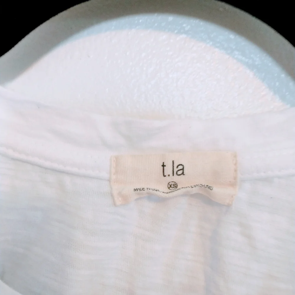 T.la Anthropologie white tank top with ruffle hem size xs